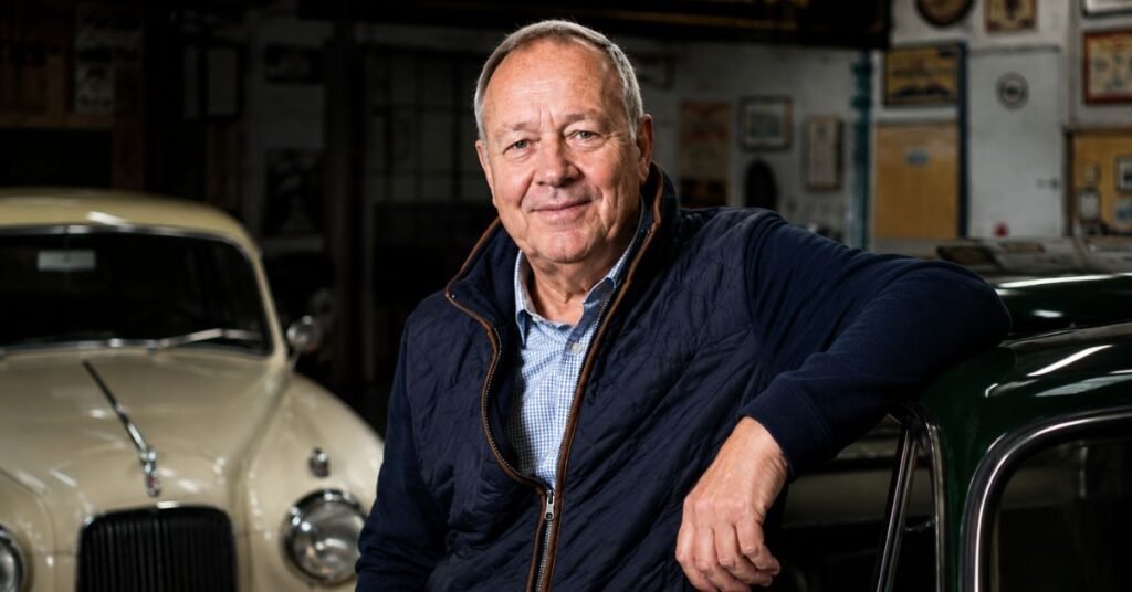 Derek Mathewson standing beside a classic car at his Mathewsons auction house in North Yorkshire, UK