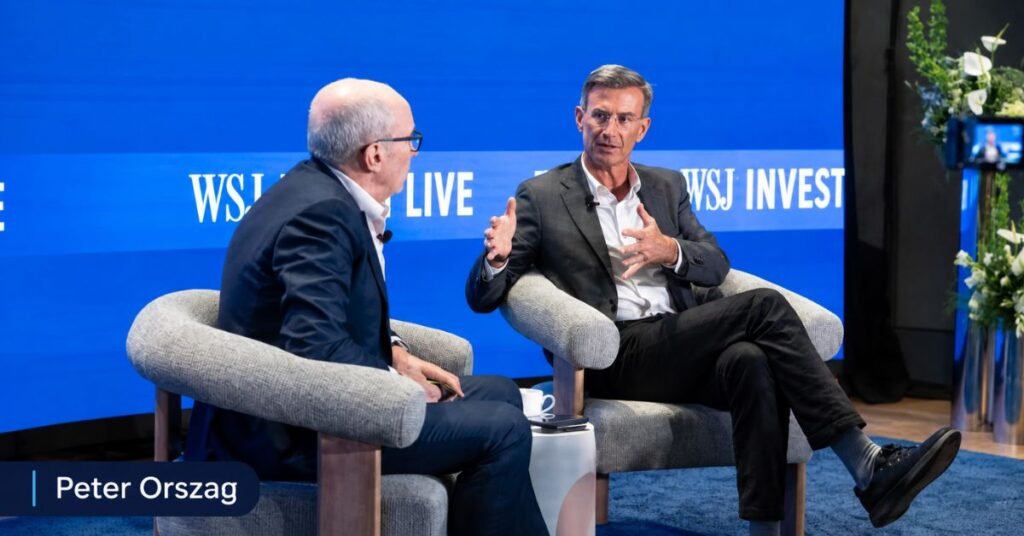 Peter Orszag speaking at a financial conference, discussing global economy and dealmaking trends