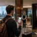 Person comparing hotel booking prices online to find the best travel tweaks for hotels