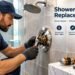Licensed plumber installing a new shower valve behind an open bathroom wall access panel this month.