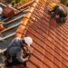 Red clay tile roof on a sunny home showing neat rows of orange-red barrel tiles and a straight ridge