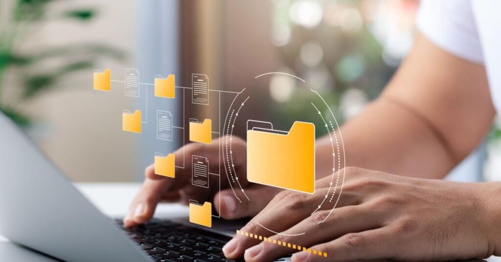 Small business owner organizing digital folders on a laptop with a clean and easy-to-use file system