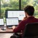 Freelancer reviewing a project list on a laptop to organize work for several clients