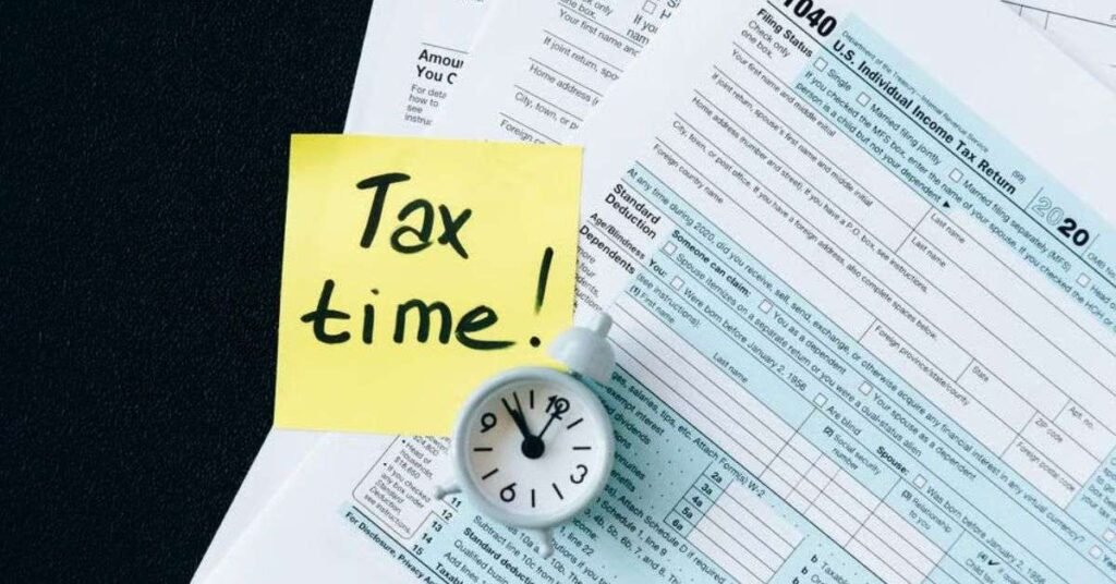 Small business owner reviewing LLC and S Corp structure options with a laptop and tax documents at a desk